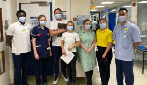 Christina Morgan and Iain Howard pictured with members of staff on Ward 27.