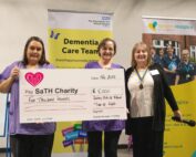 Dementia team with with the representative from the Rotary Club holding a cheque.