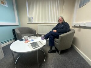 Image of Karen, Professional Nurse Advocate with the table and chairs purchased by SaTH Charity